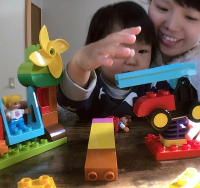 ブロックのおもちゃで遊ぶお子さまと保護者