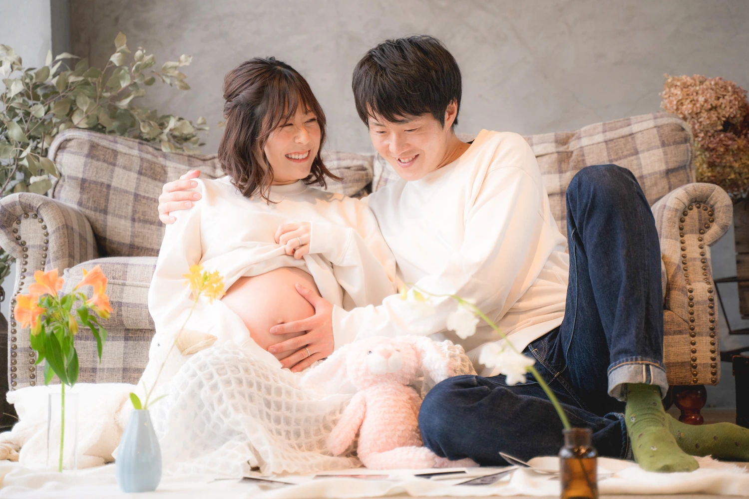 おなかに手を添え、お子さまを迎える日を楽しみに待つ妊婦さん